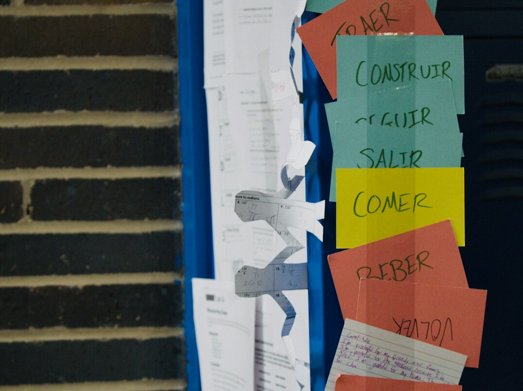Whiteboard covered with sticky notes and diagrams